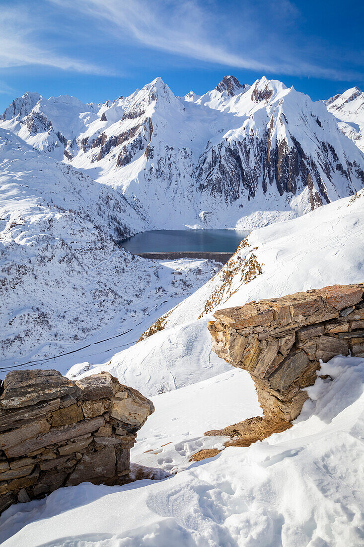 View of the Morasco lake and dam from the road to the Maria Luisa refuge and the high Formazza Valley. Riale hamlet, Riale, Formazza, Valle Formazza, Verbano Cusio Ossola, Piedmont, Italy.