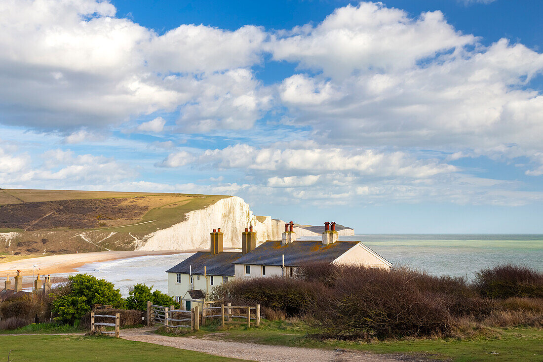 View of the Seven Sisters cliffs and the coastguard cottages, from Seaford Head across the River Cuckmere. Seaford, Sussex, England, United Kingdom.