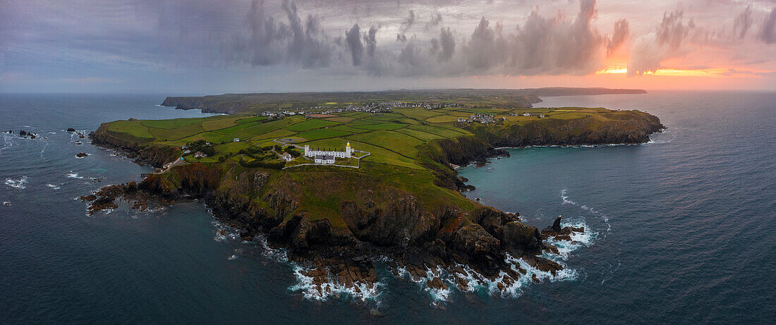 Aerial and panoramic view of Lizard Point Lighthouse at sunrise, Lizard Point, Cornwall, United Kingdom, Northern Europe