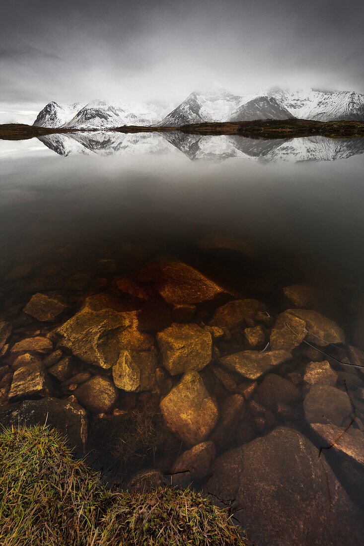 Mountain reflections at Gimsoysand during stormy weather, Vagan, Nordland, Lofoten, Norway, Northern Europe