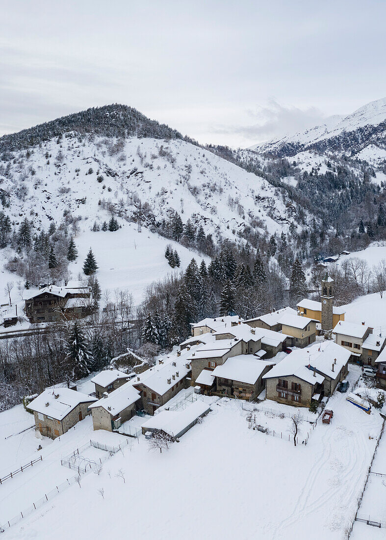 Aerial view of the small village of Rusio after a winter snowfall. Rusio, Castione della Presolana, Val Seriana, Bergamo district, Lombardy, Italy.