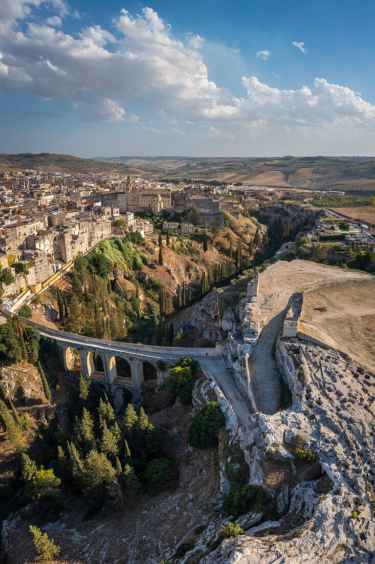 Blick auf die Altstadt von Gravina in Apulien mit der Basilika, der Aquäduktbrücke über die Schlucht und dem archäologischen Park. Provinz Bari, Apulien, Italien, Europa.