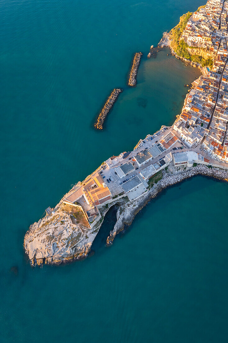 Aerial view of Vieste old town peninsula during a summer sunrise. Foggia province, Gargano National Park, Apulia, Italy.