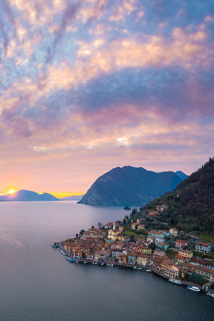 Aerial view of Monte Isola and Peschiera Maraglio village at sunset on Iseo lake. Peschiera Maraglio, Montisola, Brescia province, Lombardy district, Italy, Europe.