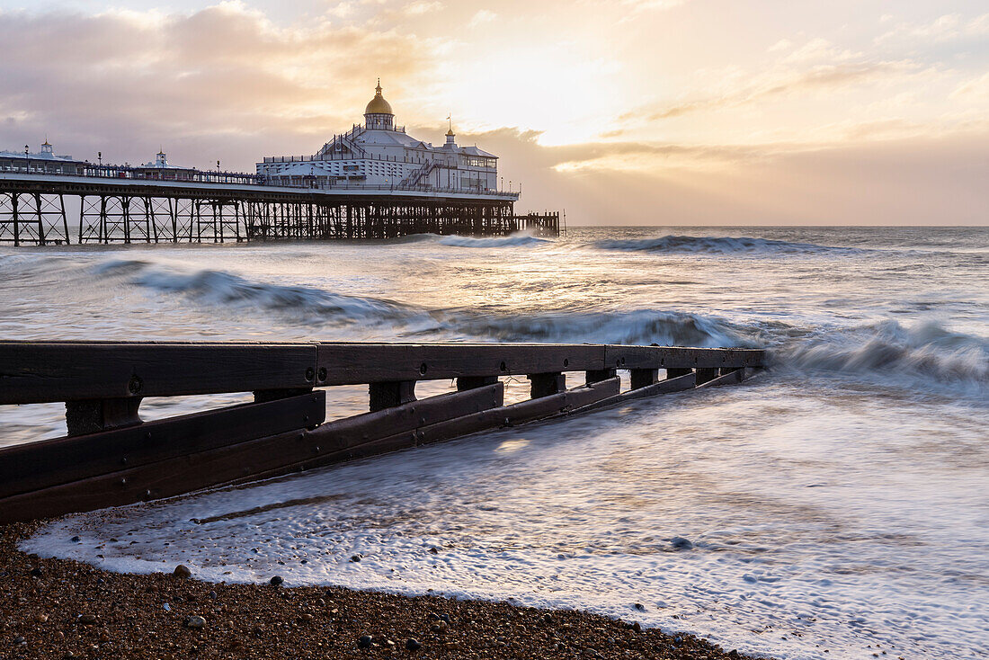 View of the Palace pier at sunrise. Brighton, East Sussex, Southern England, United Kingdom.