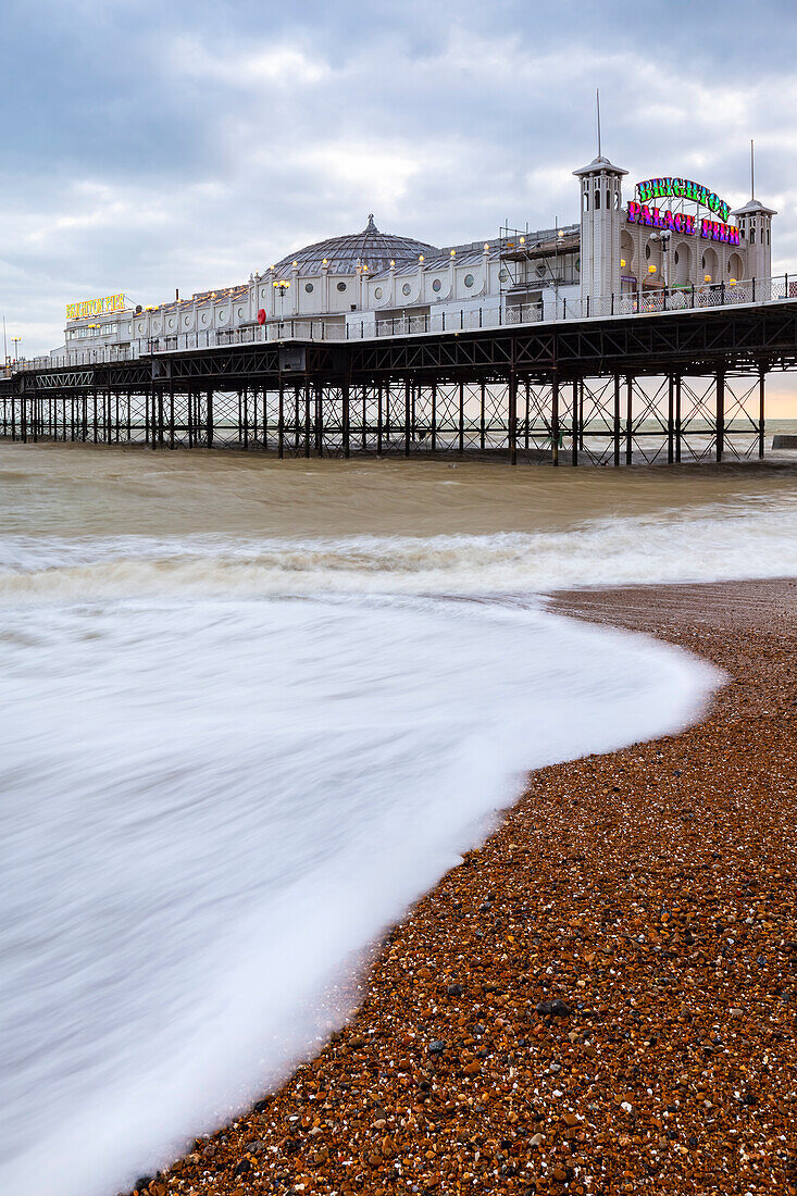 View of the Palace pier at sunset. Brighton, East Sussex, Southern England, United Kingdom.