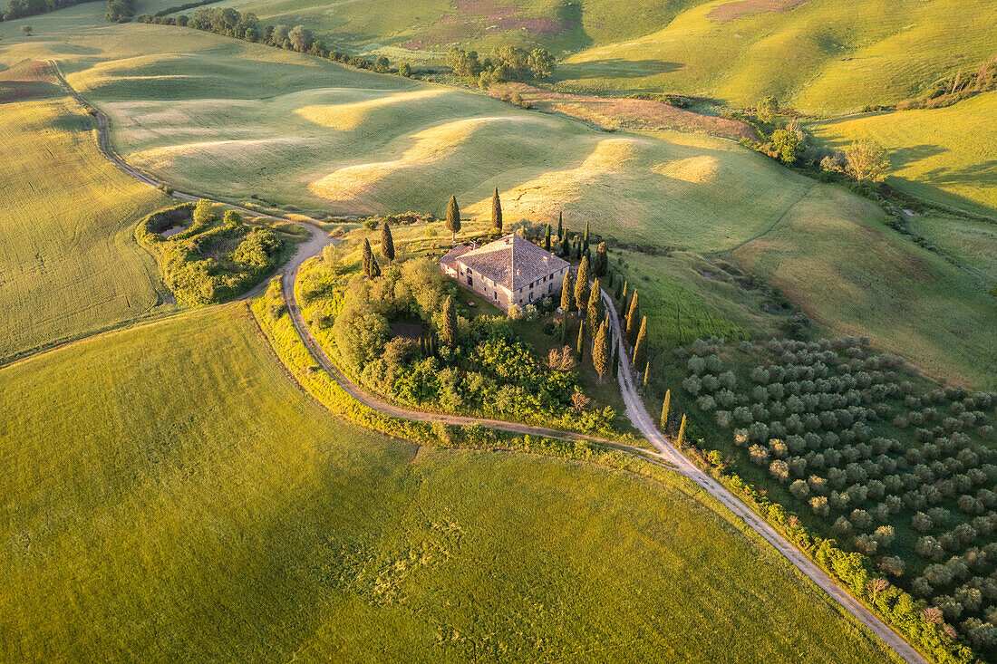 Aerial view of the famous Podere Belvedere and the surrounding countryside at sunrise. San Quirico d'Orcia, Val d'Orcia, Tuscany, Italy.