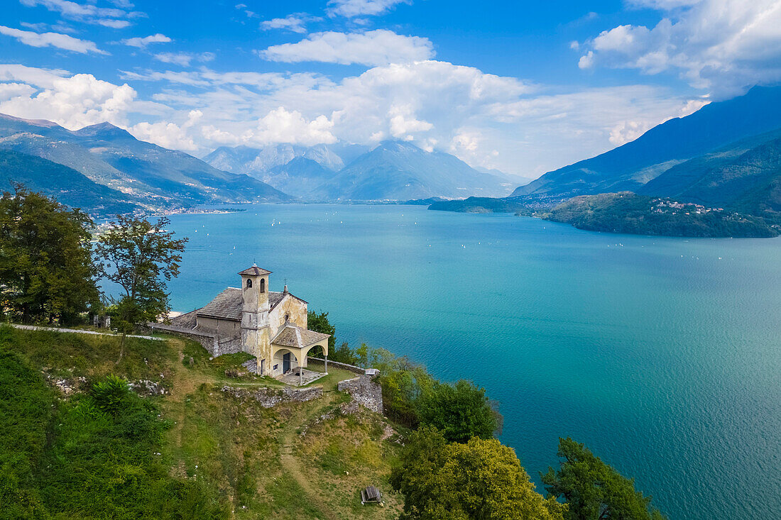 Aerial view of the church of Sant'Eufemia in Musso overlooking Lake Como. Musso, Como district, Lake Como, Lombardy, Italy
