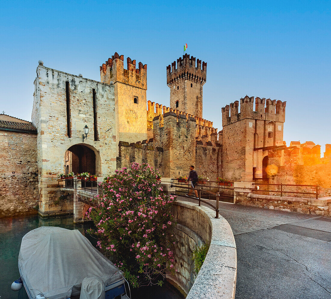 Scaliger Castle of Sirmione, entrance at sunrise with tourist, Lake of Garda, Sirmione, Brescia province, Italy, North Italy, Europe, south Europe