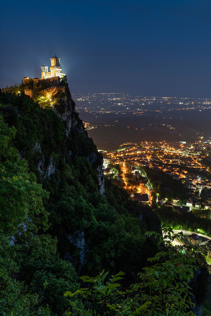 Europe, Italy, San Marino: night view of the castle above the city