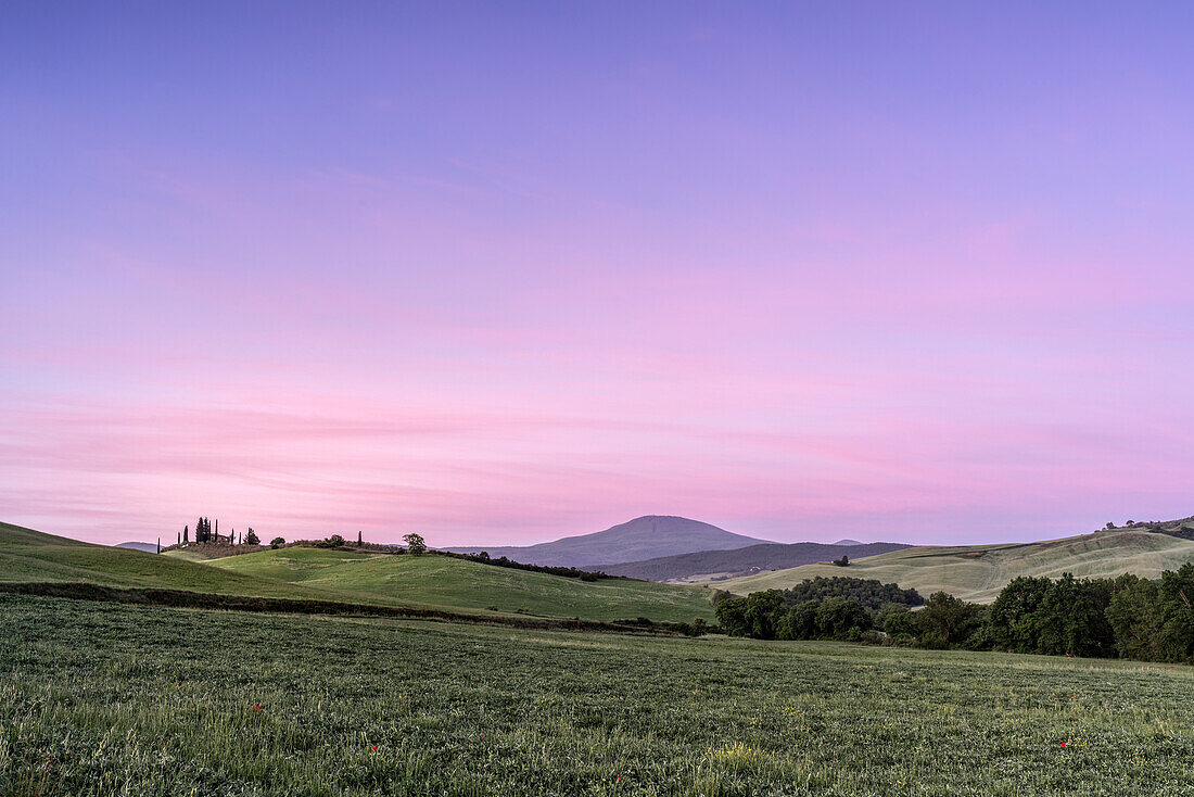 Europe, Italy, Tuscany, Val d'Orcia: the change of colours between night and day above the sleeping hills near Poggio Covili