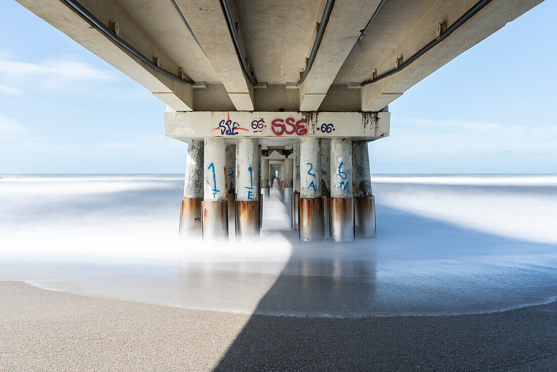 Europe, Italy, Tuscany: under a pier on Massa Carrara's seashore