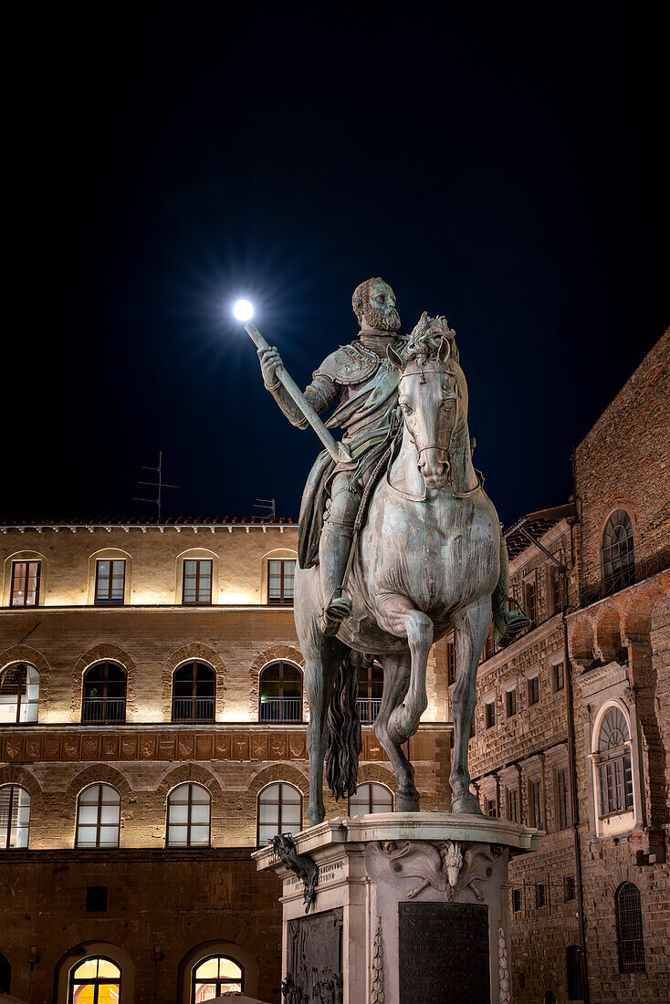 Europe, Italy, Florence: Cosimo de' Medici statue in the heart of Santa Croce Square at night