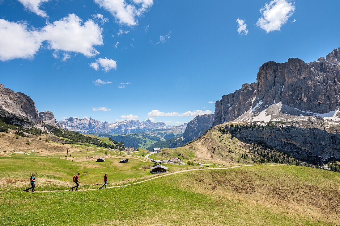 Passo Gardena, Dolomites, South Tyrol, Italy. Hikers on a hiking trail above the Gardena Pass