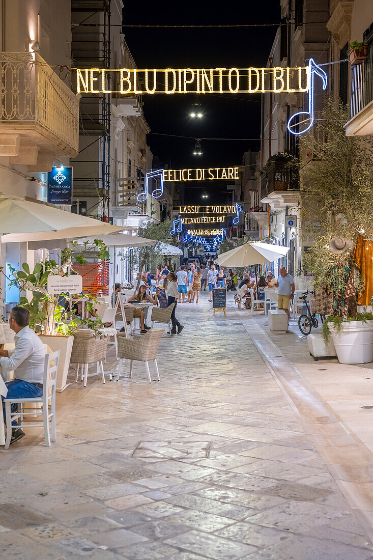 Polignano a Mare, bari, Apulia, Italy. In the street the song "nel blu dipinto di blu" by Domenico Modugne is shown as light script