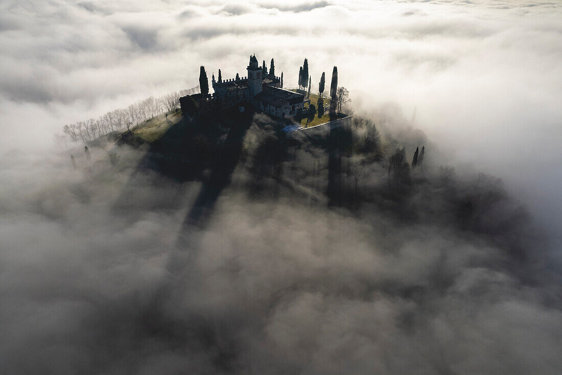 Santissima di Gussago over the clouds in Franciacorta, Brescia province in Lombardy, Italy.