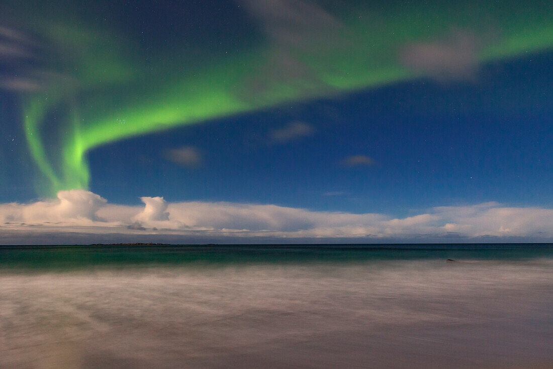 Reine, Lofoten, Norway. Aurora Borealis lights up the night sky.