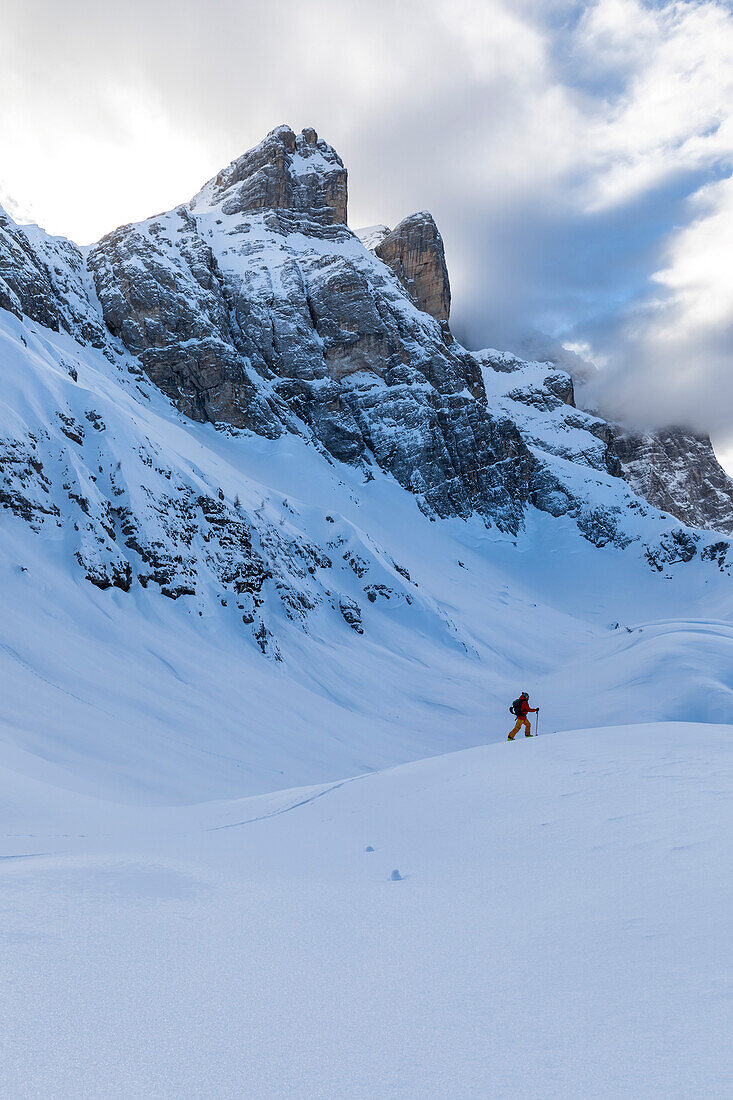 Skitouring at Coldai Lake with Civetta Peak in the background. Veneto, Italy, Europe.