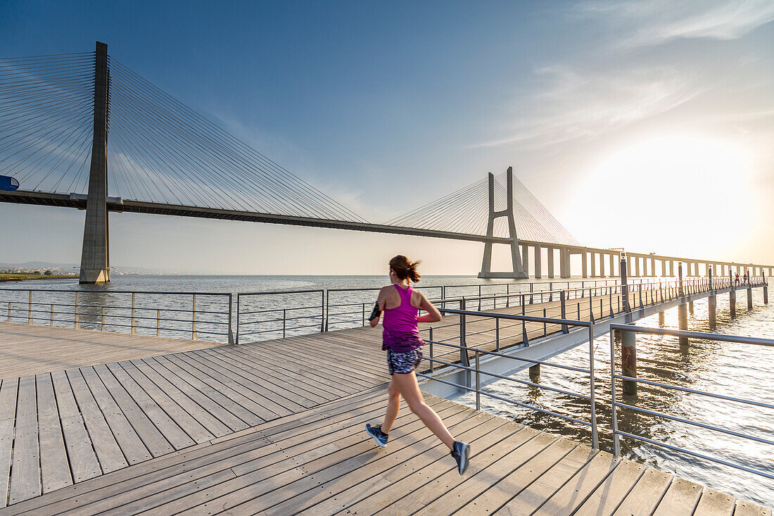 Morning run close to Vasco Da Gama bridge at sunrise, Lisbon, Portugal