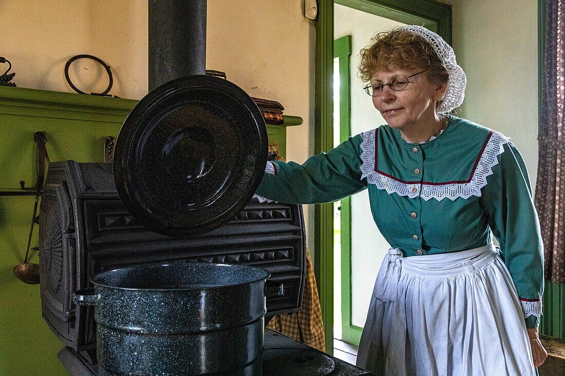 Woman at the stove, perley farm, kings landing, historic anglophone village, prince william parish, fredericton, new brunswick, canada, north america