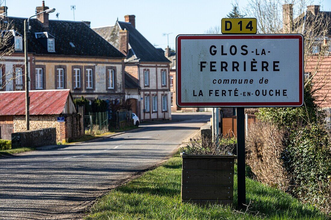 Sign for the village of glos-la-ferriere in reference to it industrial past in the iron industry, eure, normandy, france