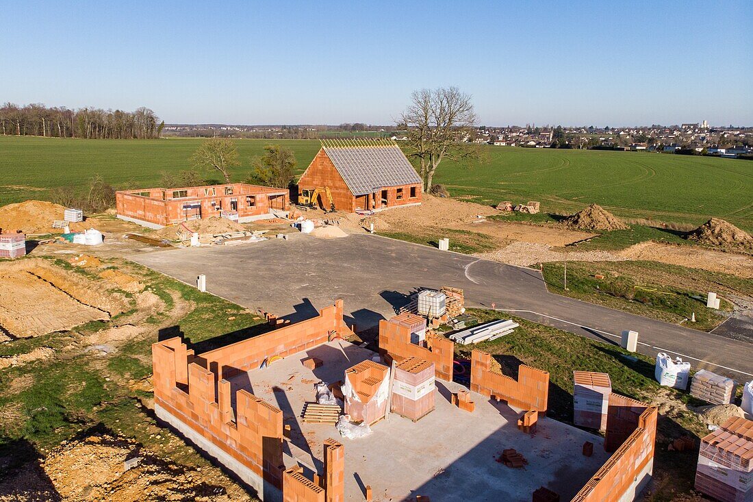 Housing development of individual homes under construction gaining ground over the farmlands, rugles, eure, normandy, france