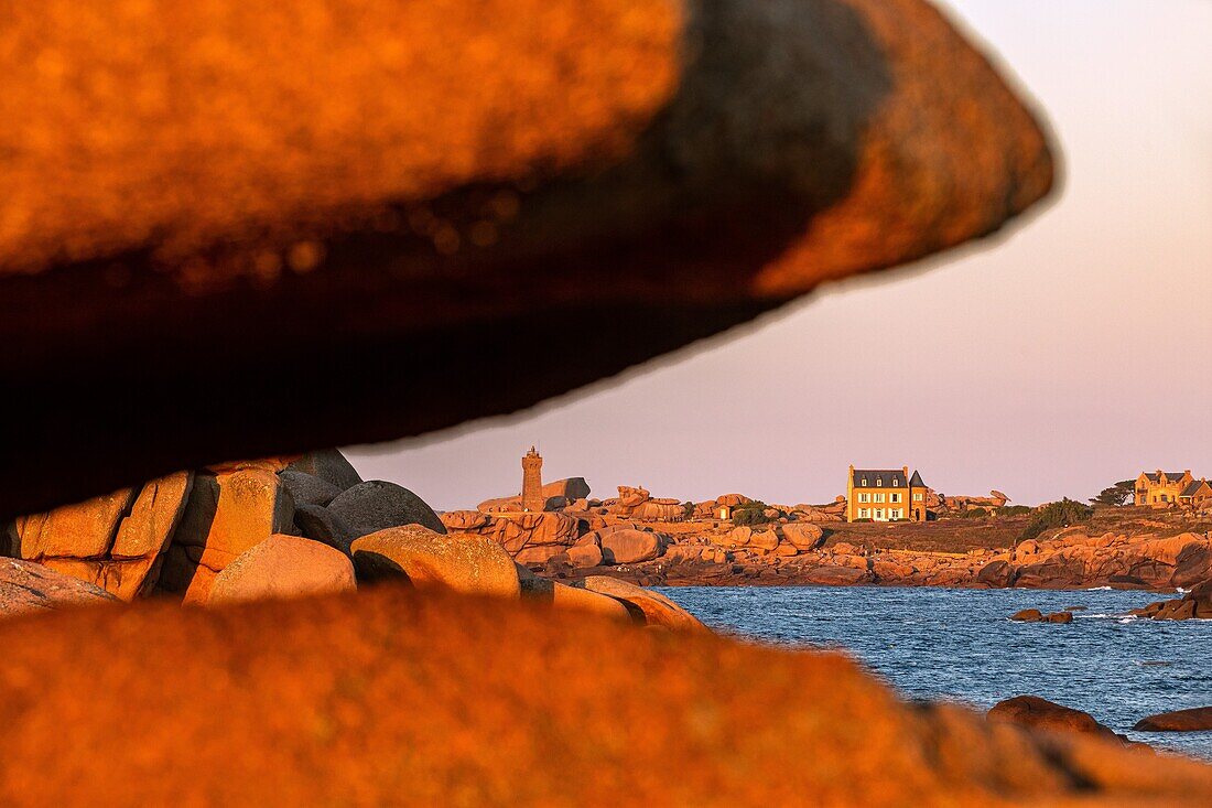 View from the pink granite boulders of the ploumanach lighthouse at sunset, renote island point, tregastel, pink granite coast, cotes-d’armor, brittany, france