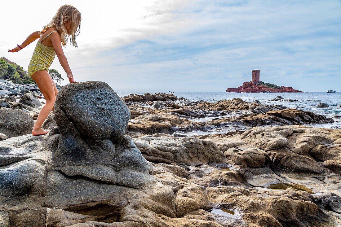 Children playing on the rocks near the port of poussai, cap esterel, saint-raphael, var, france