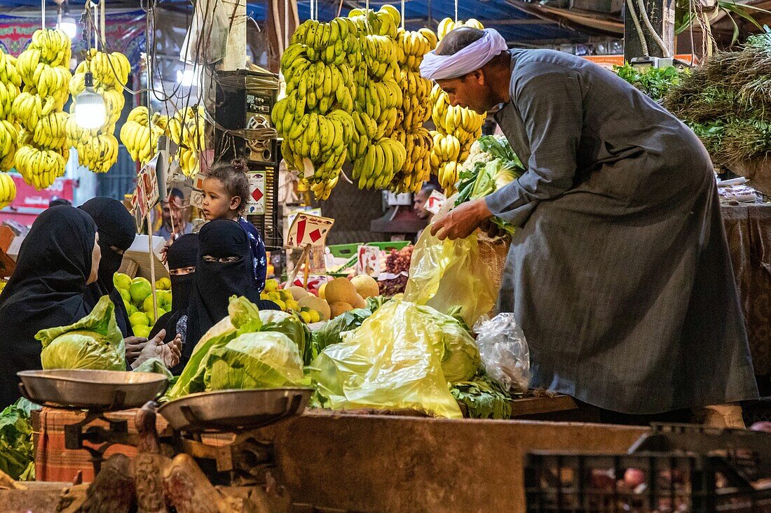 Veiled women in their full black burqa, fruit and vegetable stand, el dahar market, popular quarter in the old city, hurghada, egypt, africa