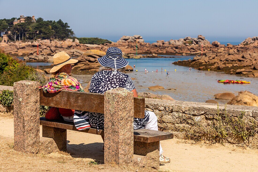 Women in hats in front of the beach of perros-guirec, cote de granit rose (pink granite coast), cotes-d'amor, brittany, france