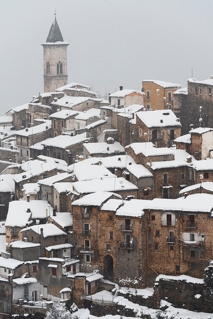The medieval village of Pacentro under heavy snowfall with snow covered house and tower bell, Pacentro municipality, Maiella national park, L’aquila province, Abruzzo, Italy