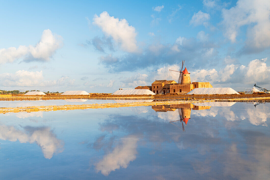 Windmill reflection in the water of the salt flats, saline dello Stagnone, Marsala, Trapani province, Sicily, Italy