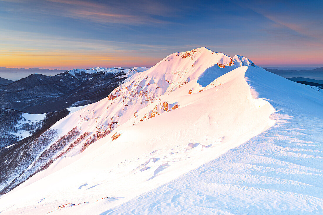 Panoramic view at the sunrise of the snow mountain ridge of Viglio mountain, Apennines, Simbruini regional park, Frosinone province, Latium, Italy