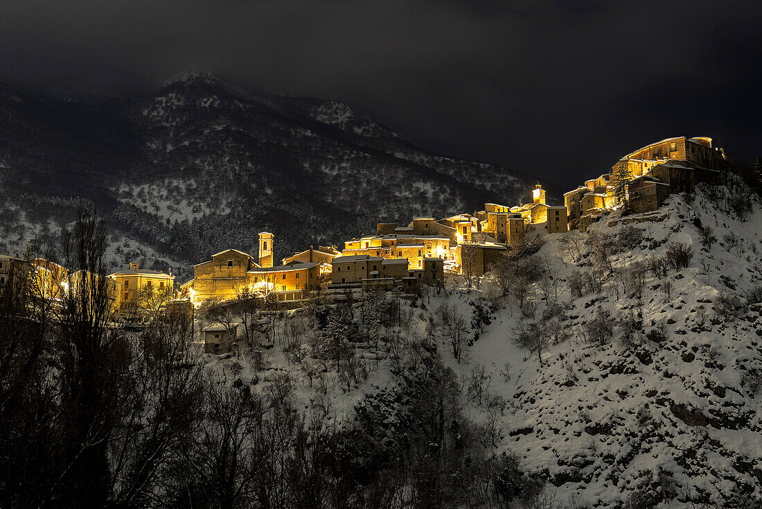 Night view on the illuminated snow covered village of Villalago, Abruzzo national park, L’aquila province, Abruzzo, Italy