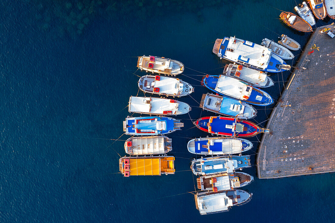 Aerial view of colourful boats and fishing vessels docked at the harbour of Ponza at sunset, Ponza island, Archipelago Pontino, Latina province, Latium, Italy