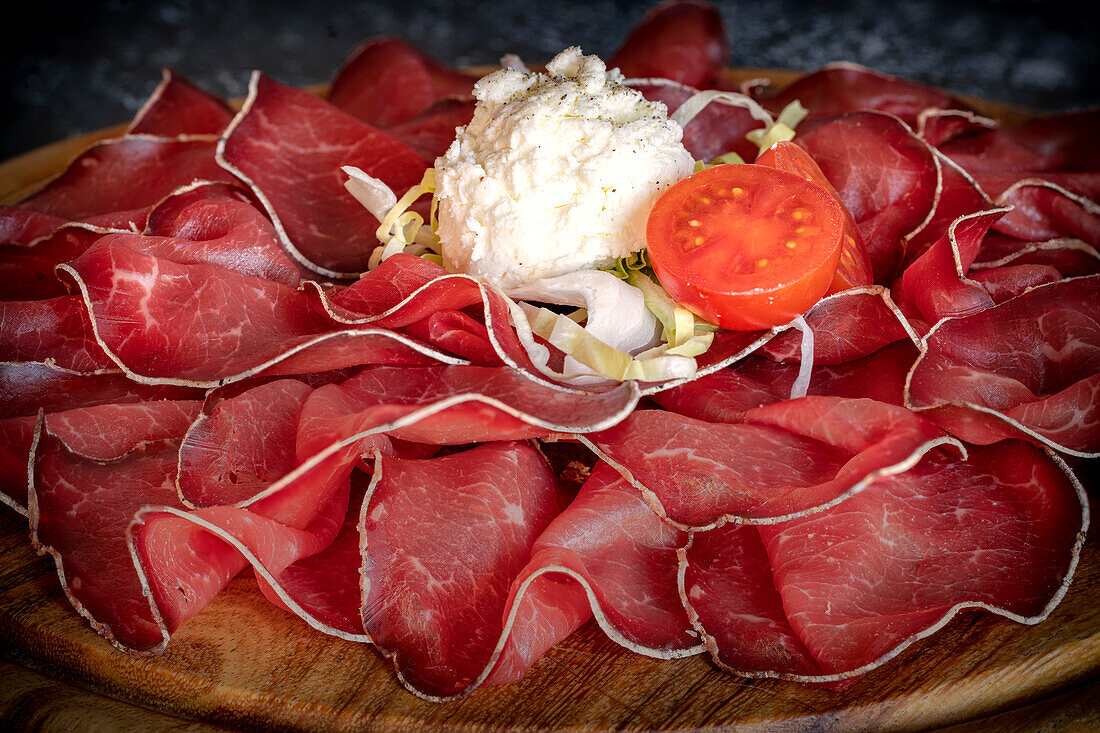 Appetizer of Bresaola dry-cured meat from Valtellina, Northern Italy