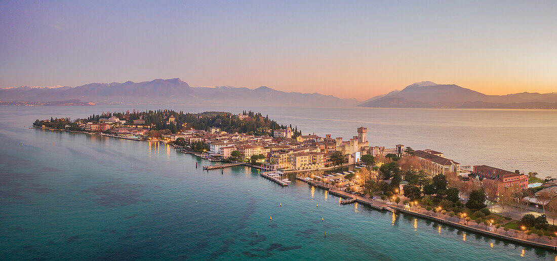 Peninsula of Sirmione during the sunset surrounded by crystal clear water of Garda Lake