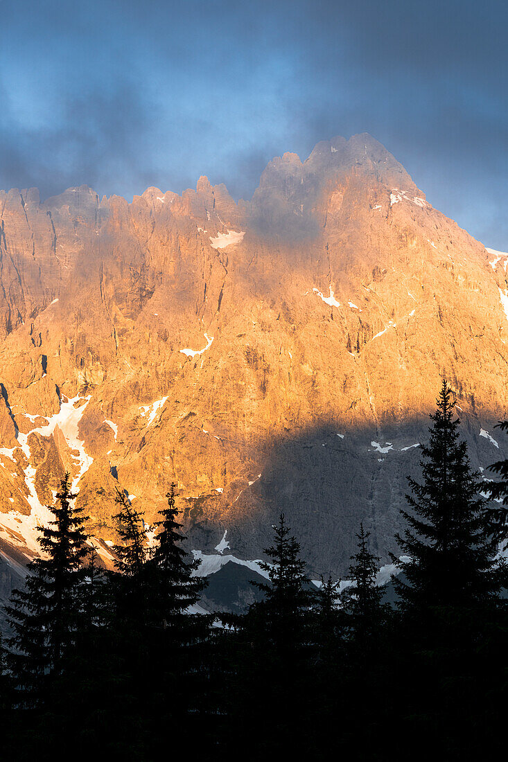 Mist at sunrise over the majestic mountains of Croda Rossa di Sesto and Cima Undici, Sesto Dolomites, South Tyrol, Italy