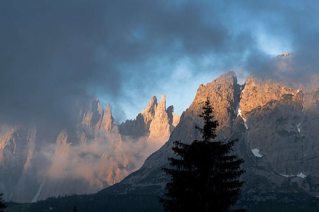 Mist at dawn over Popera group mountains and Selvapiana in summer, Sesto Dolomites, South Tyrol, Italy
