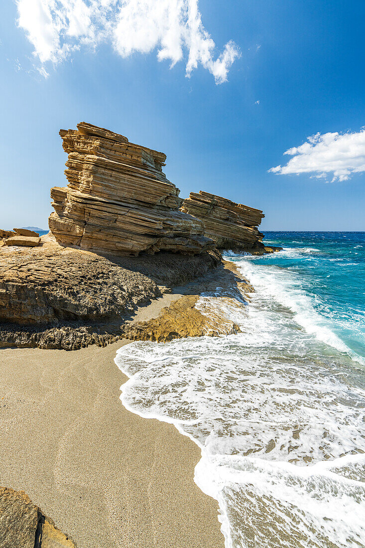 Waves crashing on limestone cliffs and white sand of Triopetra beach, Plakias, Crete island, Greece
