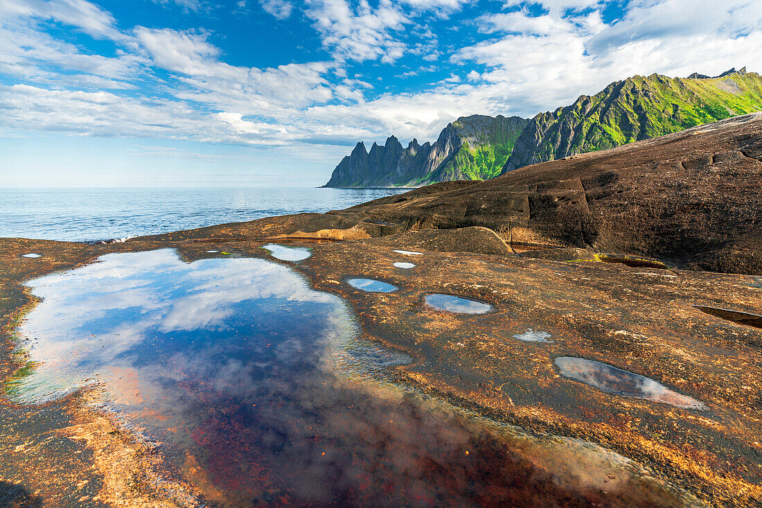 Devil's Teeth mountain peaks view from rock formation along the fjord, Tungeneset, Senja, Troms county, Norway