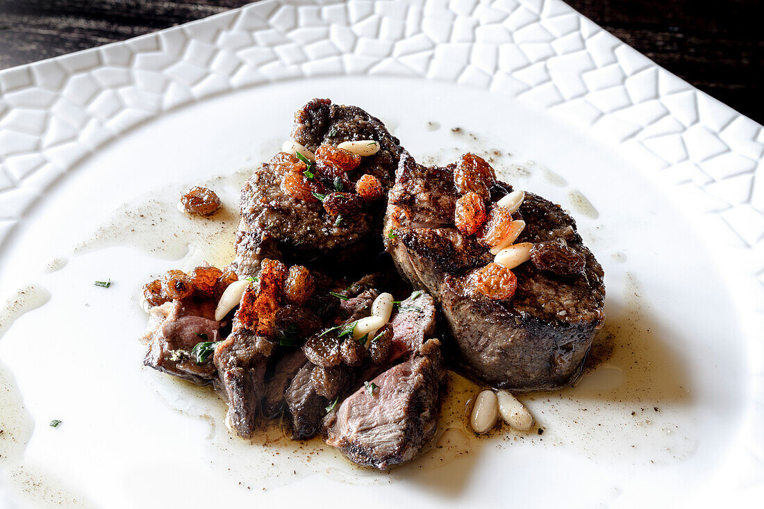 Fillet of deer meat with pine nuts and raisins, Italy