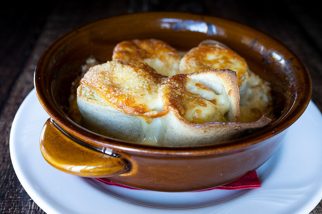 Bowl of Manfrigole crepes of Taroz with bechamel and Porcini mushrooms, traditional food of Valtellina, Lombardy, Italy