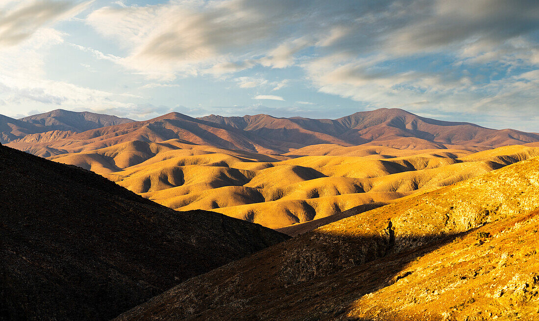 Rolling volcanic landscape at sunset from Sicasumbre astronomical viewpoint, Fuerteventura, Canary Islands, Spain