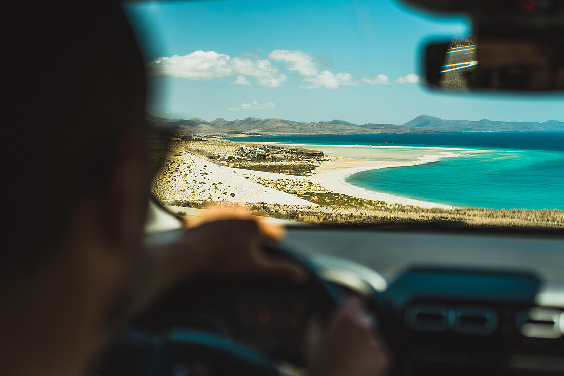 Mann bewundert den Strand Sotavento aus dem Autofenster, Naturpark Jandia, Costa Calma, Fuerteventura, Kanarische Inseln, Spanien