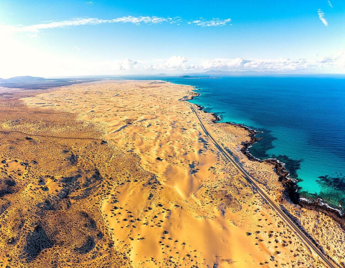 Luftaufnahme von Wüstensanddünen neben dem Meer im Naturpark Corralejo, Fuerteventura, Kanarische Inseln, Spanien