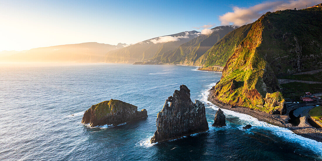 Aerial panoramic of Ilheus da Rib and Ribeira da Janela rock formations at dawn, Atlantic Ocean, Madeira island, Portugal