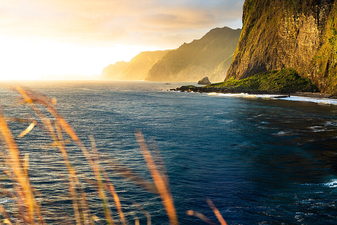 Majestic cliffs at Miradouro Do Guindaste viewpoint lit by the warm sunrise, Faial, Madeira island, Portugal