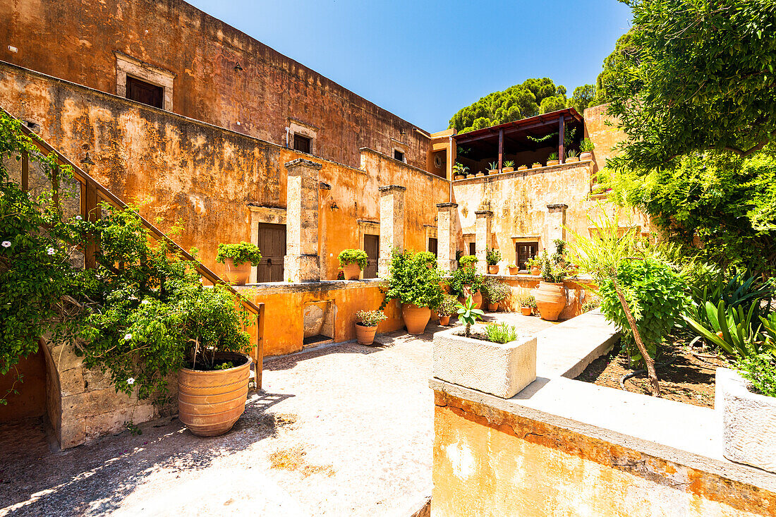 Flowerpots and plants in the ancient courtyard of Agia Triada monastery, North Chania, Crete island, Greece