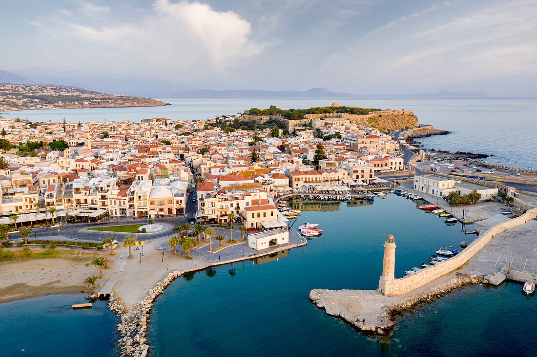 Aerial view of the old Venetian port and lighthouse at sunrise, Rethymno, Crete island, Greece